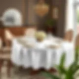 A beautifully set dining table with a 60-inch oval tablecloth showcasing elegant tableware