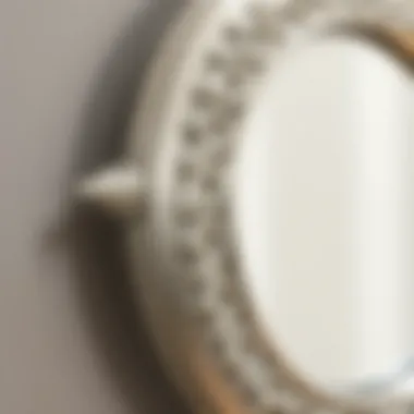 Close-up of intricate craftsmanship on a silver-framed round mirror