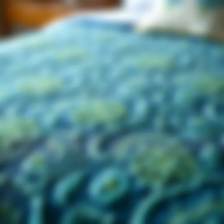 Close-up of intricate patterns on a blue and green coverlet
