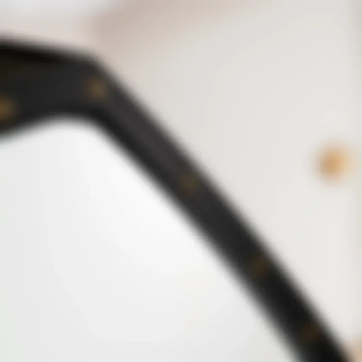 Close-up of the frame detail of a black industrial full-length mirror