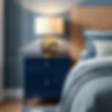 Stylish dark blue bedside table with modern lamp